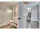 Bathroom featuring a shower-tub combination, a vanity with a door a pull-out drawers, and views to the staircase at 325 Aldridge Ln, Davenport, FL 33897