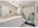 Elegant bathroom features double sinks, modern fixtures, vanity, and a beautifully designed shower curtain at 325 Aldridge Ln, Davenport, FL 33897