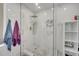 Beautiful bathroom shower with marble tile, glass door, gold hardware and fixtures at 325 Aldridge Ln, Davenport, FL 33897