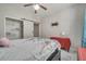 Cozy bedroom featuring a sliding door closet, bed with floral bedding, and soft lighting at 325 Aldridge Ln, Davenport, FL 33897
