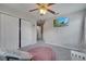 Comfortable bedroom features a ceiling fan, TV, and closet, offering a great space at 325 Aldridge Ln, Davenport, FL 33897
