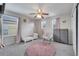 This bedroom has a ceiling fan and natural light, creating a bright and airy space at 325 Aldridge Ln, Davenport, FL 33897