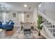 Open-concept dining room with stairway, plush seating, and natural light at 325 Aldridge Ln, Davenport, FL 33897