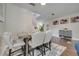 Dining room with a wooden table, stylish chairs, and view of the stairway at 325 Aldridge Ln, Davenport, FL 33897