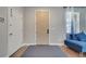 Bright entryway featuring a modern door, neutral walls, and a stylish blue bench at 325 Aldridge Ln, Davenport, FL 33897