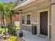 Charming front porch featuring a palm tree and a view of the home's exterior at 325 Aldridge Ln, Davenport, FL 33897