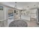 Modern kitchen with white cabinets, a center island, and sliding glass doors to the outdoor space at 325 Aldridge Ln, Davenport, FL 33897