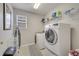 Laundry room with washer, dryer, utility sink, and shelving at 325 Aldridge Ln, Davenport, FL 33897