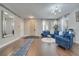Living room with blue couches, wood floors, and modern lighting at 325 Aldridge Ln, Davenport, FL 33897