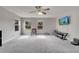 Large loft area featuring plush carpeting, multiple windows, and a ceiling fan for comfortable living at 325 Aldridge Ln, Davenport, FL 33897