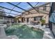 Relaxing pool area with covered seating and a view of the surrounding landscape at 325 Aldridge Ln, Davenport, FL 33897