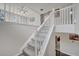 Carpeted staircase with white railings, showcasing a well-maintained transition between floors at 325 Aldridge Ln, Davenport, FL 33897