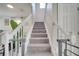 Carpeted staircase featuring white railings and a safety gate, providing a secure transition between levels at 325 Aldridge Ln, Davenport, FL 33897