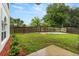 Fenced backyard featuring green grass, garden bed, and privacy at 3591 Sandlor Dr, Deltona, FL 32738