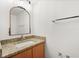 Bathroom with a vanity featuring a granite countertop and decorative mirror at 3591 Sandlor Dr, Deltona, FL 32738