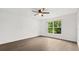 Bright bedroom featuring a ceiling fan and a large window overlooking greenery at 3591 Sandlor Dr, Deltona, FL 32738