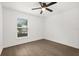 Bedroom with wood-look flooring, a window with blinds, and a ceiling fan at 3591 Sandlor Dr, Deltona, FL 32738