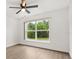 Well-lit bedroom featuring a ceiling fan and large window offering natural views at 3591 Sandlor Dr, Deltona, FL 32738