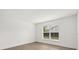 Well-lit bedroom with wood-look flooring and a large window with blinds at 3591 Sandlor Dr, Deltona, FL 32738
