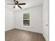Bright bedroom featuring a ceiling fan and a window overlooking the outdoor scenery at 3591 Sandlor Dr, Deltona, FL 32738