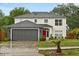 Charming two-story home featuring a well-maintained lawn and inviting red front door at 3591 Sandlor Dr, Deltona, FL 32738