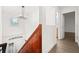 Hallway featuring hardwood stairs, view of front door and the second bathroom at 3591 Sandlor Dr, Deltona, FL 32738