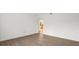 Bright living room area with wood-look flooring and a glimpse into the kitchen at 3591 Sandlor Dr, Deltona, FL 32738