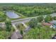 Aerial view of property near pond, green space, and access to highway at 37 N Tymber Crk, Ormond Beach, FL 32174