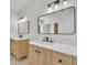 Updated bathroom featuring double vanities, modern fixtures, and bright lighting at 37 N Tymber Crk, Ormond Beach, FL 32174
