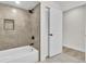 This bathroom features a tub with shower and a gray tile surround at 37 N Tymber Crk, Ormond Beach, FL 32174