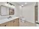 Modern bathroom with wood vanity, marble countertop, framed mirror, sleek fixtures, and a tiled shower at 37 N Tymber Crk, Ormond Beach, FL 32174