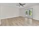 Bright bedroom featuring new flooring, ceiling fan, and double doors leading to outdoor patio at 37 N Tymber Crk, Ormond Beach, FL 32174