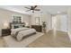 Digitally staged bedroom with a neutral palette, light hardwood flooring, and plenty of natural light at 37 N Tymber Crk, Ormond Beach, FL 32174
