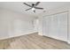 This room features hardwood floors and a ceiling fan over an off-white painted room with closet at 37 N Tymber Crk, Ormond Beach, FL 32174