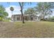 Charming home with a well-maintained lawn, and a long driveway, surrounded by lush trees at 37 N Tymber Crk, Ormond Beach, FL 32174