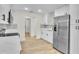Modern kitchen featuring white cabinets, stainless steel appliances, and light wood floors at 37 N Tymber Crk, Ormond Beach, FL 32174