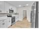 Modern kitchen with white cabinets, stainless steel appliances and light wood floors at 37 N Tymber Crk, Ormond Beach, FL 32174