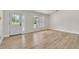 Bright living room featuring light wood floors, large window, and a modern front door at 37 N Tymber Crk, Ormond Beach, FL 32174