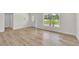 Bright living room with light wood floors, large window, and views of the outdoors at 37 N Tymber Crk, Ormond Beach, FL 32174