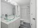 Bright bathroom featuring vessel sinks, white cabinets, and a glass shower enclosure for a modern and spacious feel at 3927 Citadel Dr, Orlando, FL 32839
