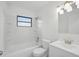 A clean bathroom showcasing a shower-tub combo, white tile, and modern fixtures with natural light at 3927 Citadel Dr, Orlando, FL 32839