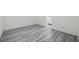 Bedroom showcasing new gray wood-look vinyl flooring and bright white trim at 3927 Citadel Dr, Orlando, FL 32839