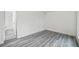 Clean bedroom featuring gray wood-look vinyl flooring with white walls at 3927 Citadel Dr, Orlando, FL 32839