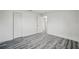 Bedroom with modern wood-look vinyl flooring and a closet with folding doors at 3927 Citadel Dr, Orlando, FL 32839