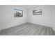 Bedroom with wood-look vinyl flooring and natural light from two windows at 3927 Citadel Dr, Orlando, FL 32839