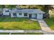 Eye-level view of a single-story home with a green lawn and tidy landscaping at 3927 Citadel Dr, Orlando, FL 32839