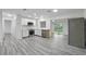 Modern, bright kitchen with white cabinetry, stainless steel appliances, and new flooring at 3927 Citadel Dr, Orlando, FL 32839