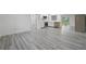 Bright, open-concept living room and kitchen with modern stainless steel appliances and light gray wood flooring at 3927 Citadel Dr, Orlando, FL 32839