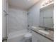 Bathroom featuring granite countertops, shower over tub with tile surround and modern fixtures at 4226 Kelly Miller Ct, Orlando, FL 32811