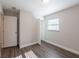 Bedroom featuring wood-look floors, neutral walls, a window, and a closet at 4226 Kelly Miller Ct, Orlando, FL 32811
